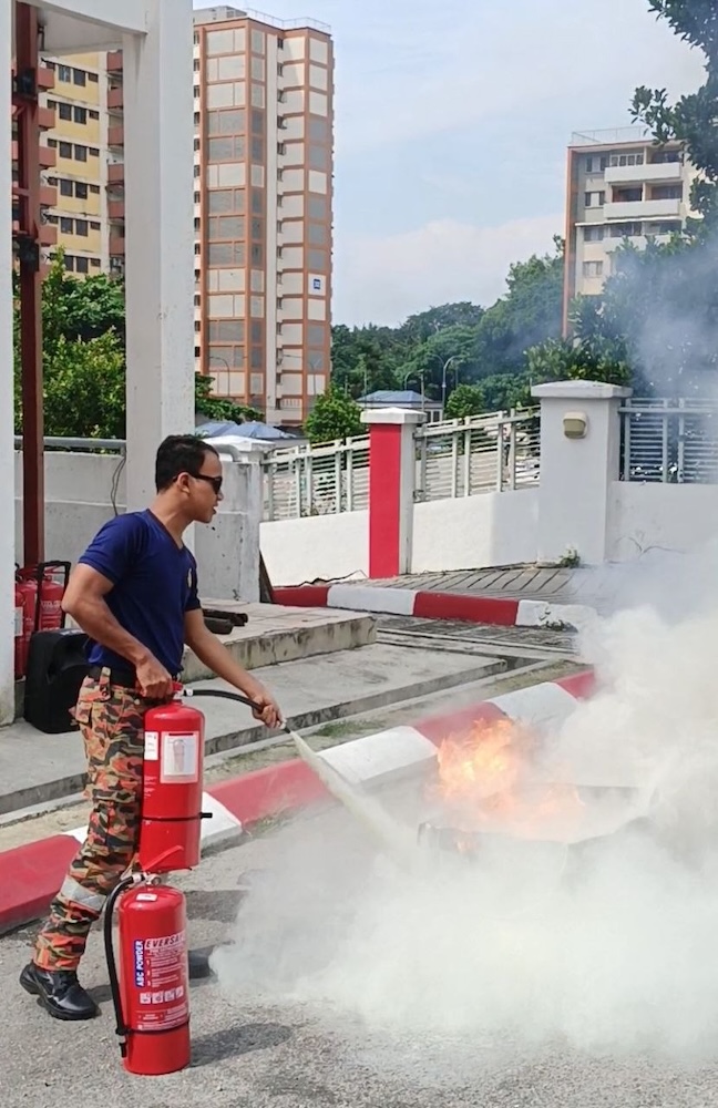 fireman-putting-out-fire-demo-hang-tuah-fire-station-kl